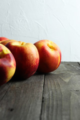 Group of ripe nectarines on dark wooden surface