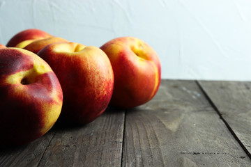 Group of ripe nectarines on dark wooden surface