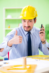 Young male architect working at the project