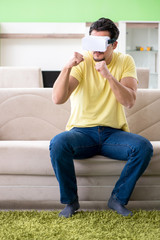 Fototapeta premium Young man with virtual reality goggles