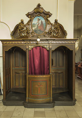 Fototapeta premium Kamien Slaski, Poland, August 28, 2018: Old confessional at St. Jack's church in Kamien Slaski near Opole
