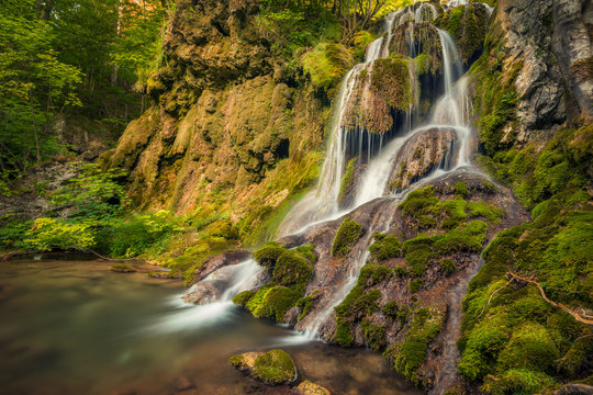 Beautiful waterfall in natural landscape with rocks and moss