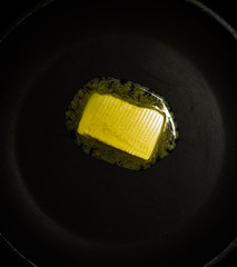 Melting butter/margarine in a heated pan