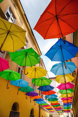 Fototapeta na wymiar Colorful floating umbrellas, street decoration