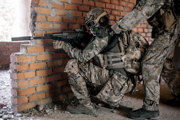 Military special forces with rifles in their hands storming the building taking a fighting position
