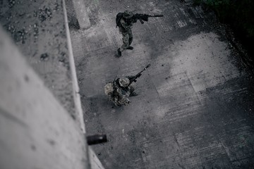 Military intelligence of the destroyed building, military soldiers storming the building, top view