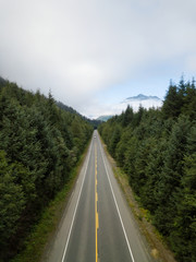 Aerial view of a scenic road in the Canadian Landscape during a vibrant cloudy summer day. Taken in Northern Vancouver Island, BC, Canada.
