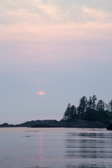 Ocean view at the rocky beach during a vibrant summer sunset. Taken on Terrace Beach, Ucluelet, Vancouver Island, BC, Canada.