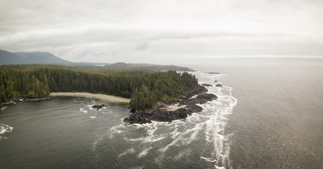 Aerial panoramic seascape view of the Pacific Ocean Coast during a cloudy summer day. Taken near Tofino and Ucluelet, Vancouver Island, BC, Canada.