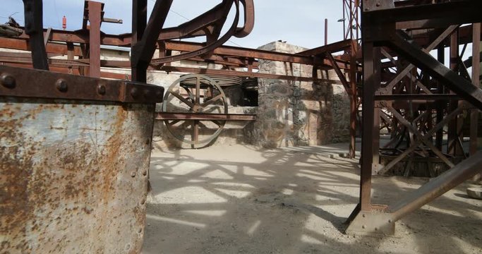 Second station of old Cable Car Chilecito-La Mejicana mine. Camera moves sideways showing detail of rusty wagon and at background wheels which made the system move. National heritage