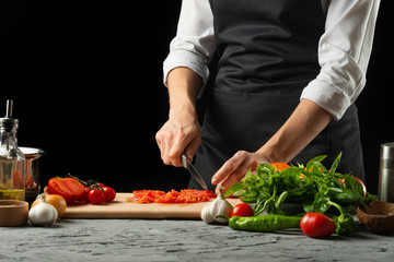 Close the chef's hands, preparing an Italian tomato sauce for macaroni.pizza. The concept of the Italian cooking recipe