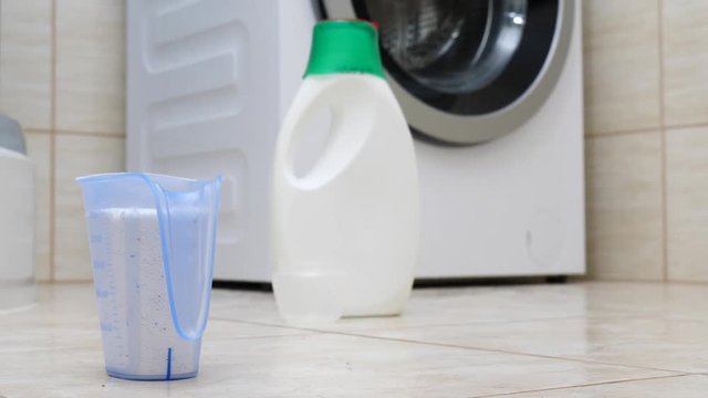 Portion of washing powder in detergent container. Bathroom laundry objects concept