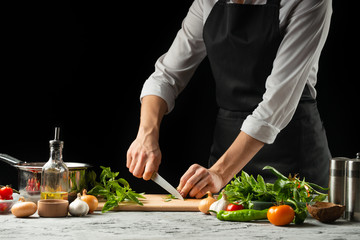 Preparation of tomato sauce by the hands of the chef, steps the process in the kitchen on a black background copy the text of the recipe.The concept of cooking food