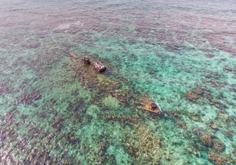 Half Submerged Shipwreck on Coral Reef