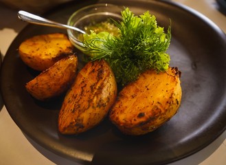 Delicious grilled potato with salad and sauce