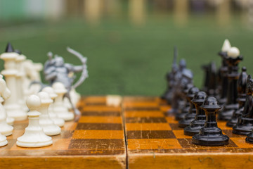 fantasy concept of soft focus black and white classic chess figures and unfocused silhouette of ...