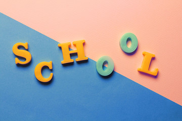 A mockup of images of the letters of the English alphabet, September 1, back to school. Background - texture of colored paper. Place for text. Selective focus, copy space, top view, flat lying