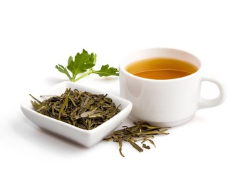 Cup of Green Tea with Dried Leaves Tea in Bowl