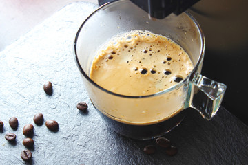 coffee glass on a stone background coffee machine