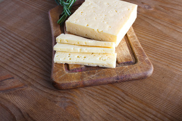 cheese cut on a wooden background