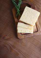 cheese cut on a wooden background