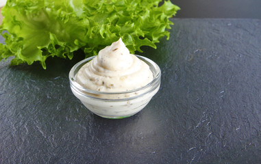 mayonnaise sauce, sour cream on a stone background