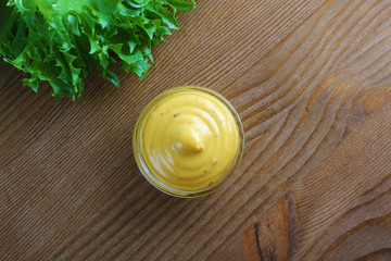 mustard sauce on a wooden background