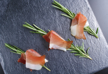 prosciutto, jamon on a stone background