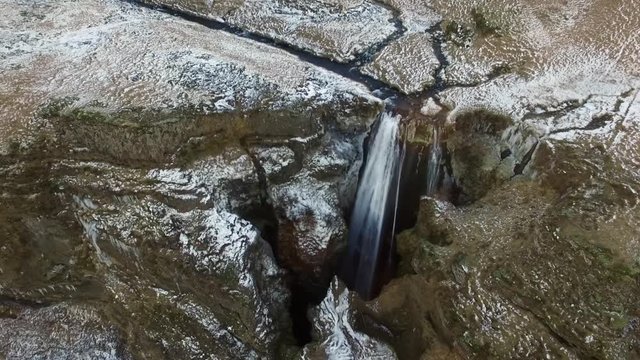 Bird's eye aerial lowering shot over Icelandic Waterfall Wide aerial shot flying towards and over Icelandic Waterfall Glj&radic;&int;frab&radic;&int;i