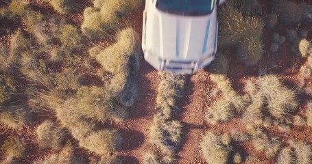 Aerial Drone hovering over gravel road with 4WD Truck driving past in vast Australian Desert