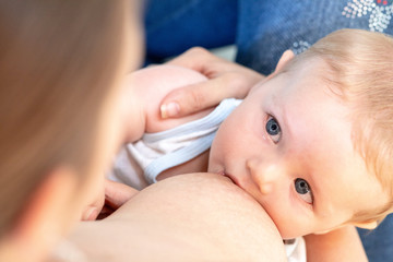Obraz na płótnie Canvas Adorable newborn baby suckling from its mother