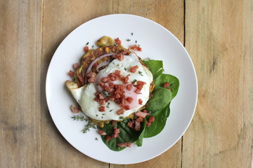 Zucchini and Sweet Potato Fritters with fried egg, bacon and salad, gourmet