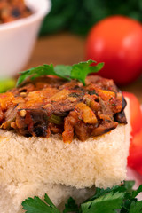 Sandwich - white bread and vegetable stew with parsley leaves, close-up, vertical frame.