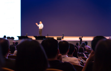 Presenter Presenting on Stage at Conference Hall Exhibition. Professional Lecture. Hand Up To...