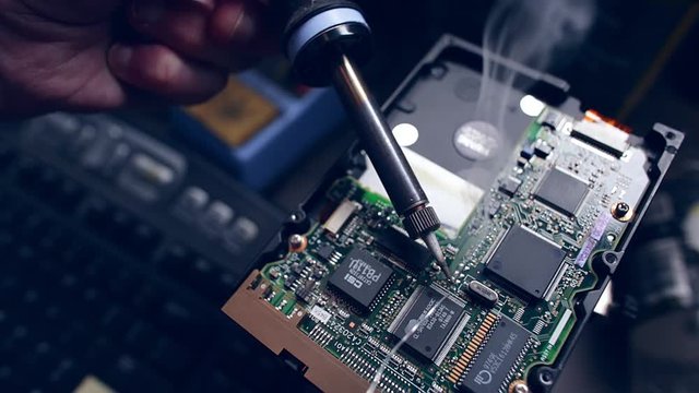 slow motion footage of solder smoking when hitting hot soldering iron