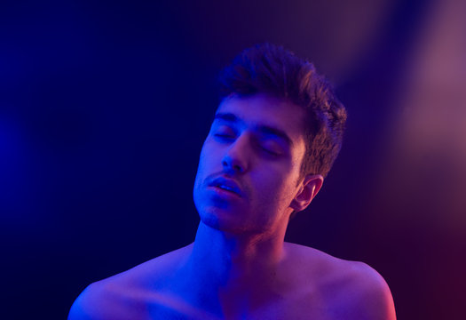 Portrait Young Man Shirtless Expresive Meditating High Sotoned Emotion With Red And Blue Light