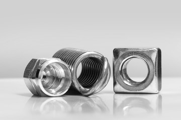 Metal nuts and spring in monochrome