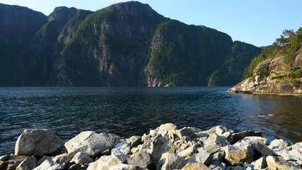 Slow pan at the norwegian fjord in the morning with sun rise.