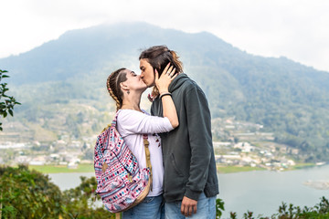Portrait of beautiful young couple enjoying nature on a mountain background.