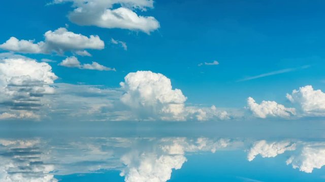 futuristic background consisting of Time lapse clip of white fluffy clouds over blue sky and their reflection, video loop