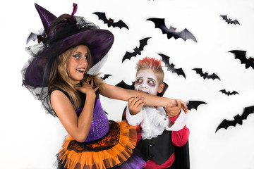 Vampire bite arm of a witch. Halloween kids, Happy scary girl and boy dressed up in halloween costumes of witch, sorcerer and vampire, Dracula for pumpkin patch and halloween party
