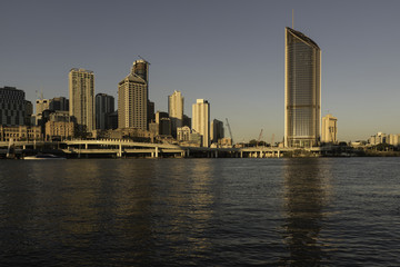 Brisbane city skyline viewed at sunset from the south bank of the Brisbane River. Queensland, Australia.