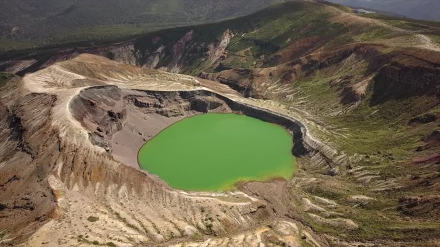 Aerial shot of Okama crater lake in Yamagata Japan.