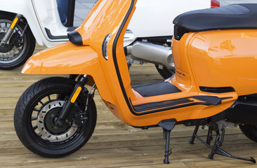 details of orange moped closeup, outdoors