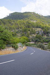 Scenic View of Asphalt Road Leading to Mountain in Mallorca, Spain