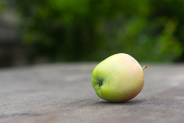 Ripe juicy apple on wooden table