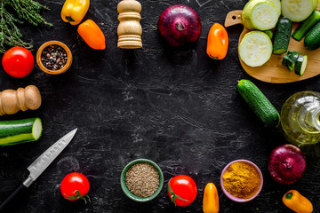 Vegetarian food concept. Set of vegetables for stew. Squash, bell pepper, tomato, spices, oil on black background top view space for text