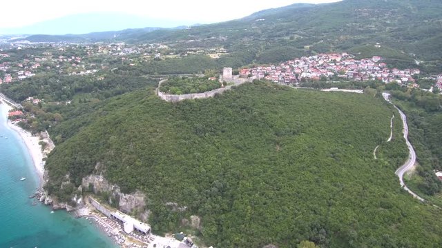 Aerial view of castle on the top of the hill, down the ocean .