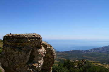 Photo of nature - lone big stone on a mountain summit on blue sky background