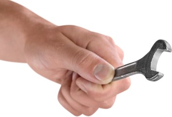 Hand holding a wrench
